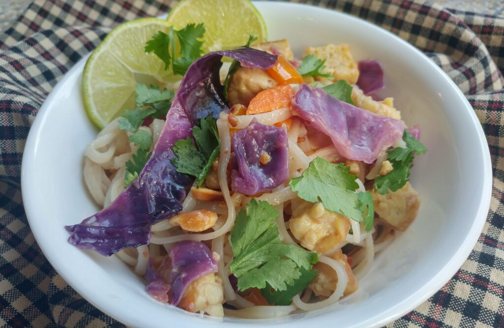 Tempeh pad thai with broccoli and corn