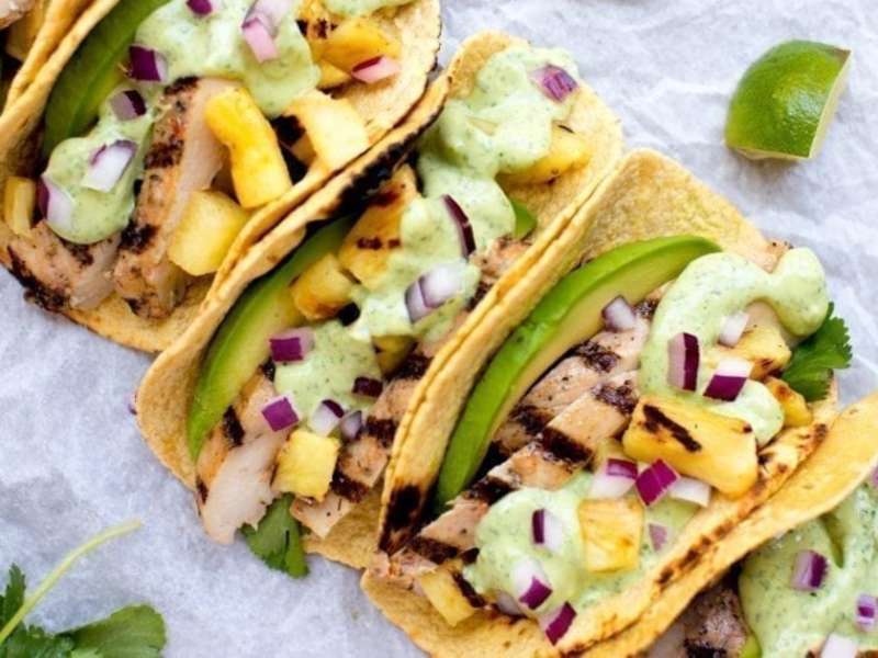 Grilled pineapple chicken tacos with avocado crema