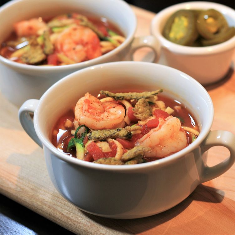 Spicy tortilla soup with shrimp and avocado