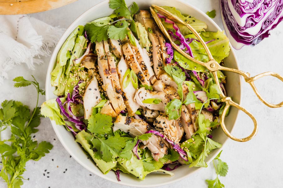 Shredded vegetable salad with sesame chicken strips